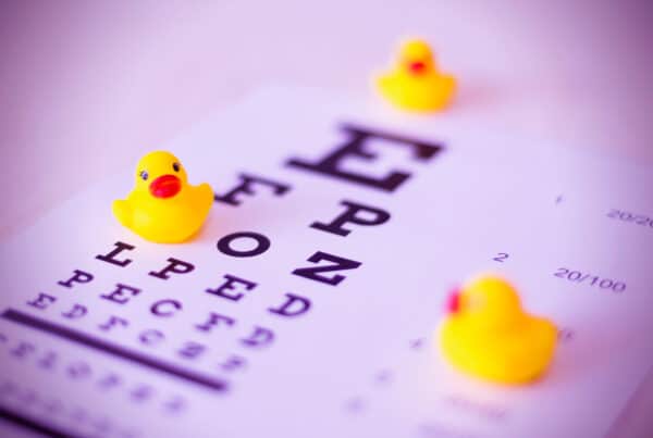 Eye chart with three yellow small rubber ducks sitting on top