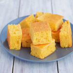Slices of cornbread on a blue plate